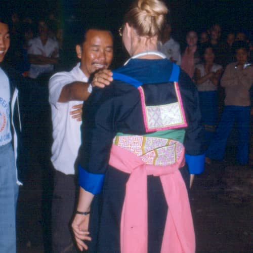 A woman with a baby carried in an embroidered cloth