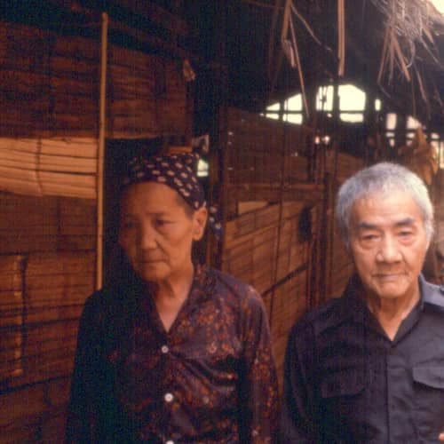 An elderly Hmong couple standing together
